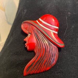 Pin brooch, Bakelite carved painted woman, long hair, red hat
